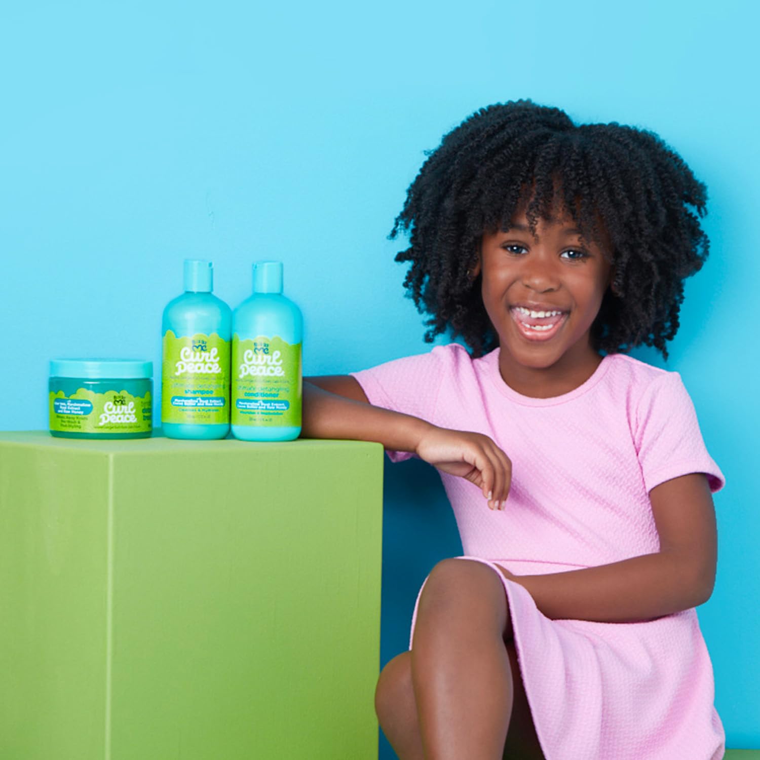 Just For Me lifestyle image of smiling child with defined, manageable curls