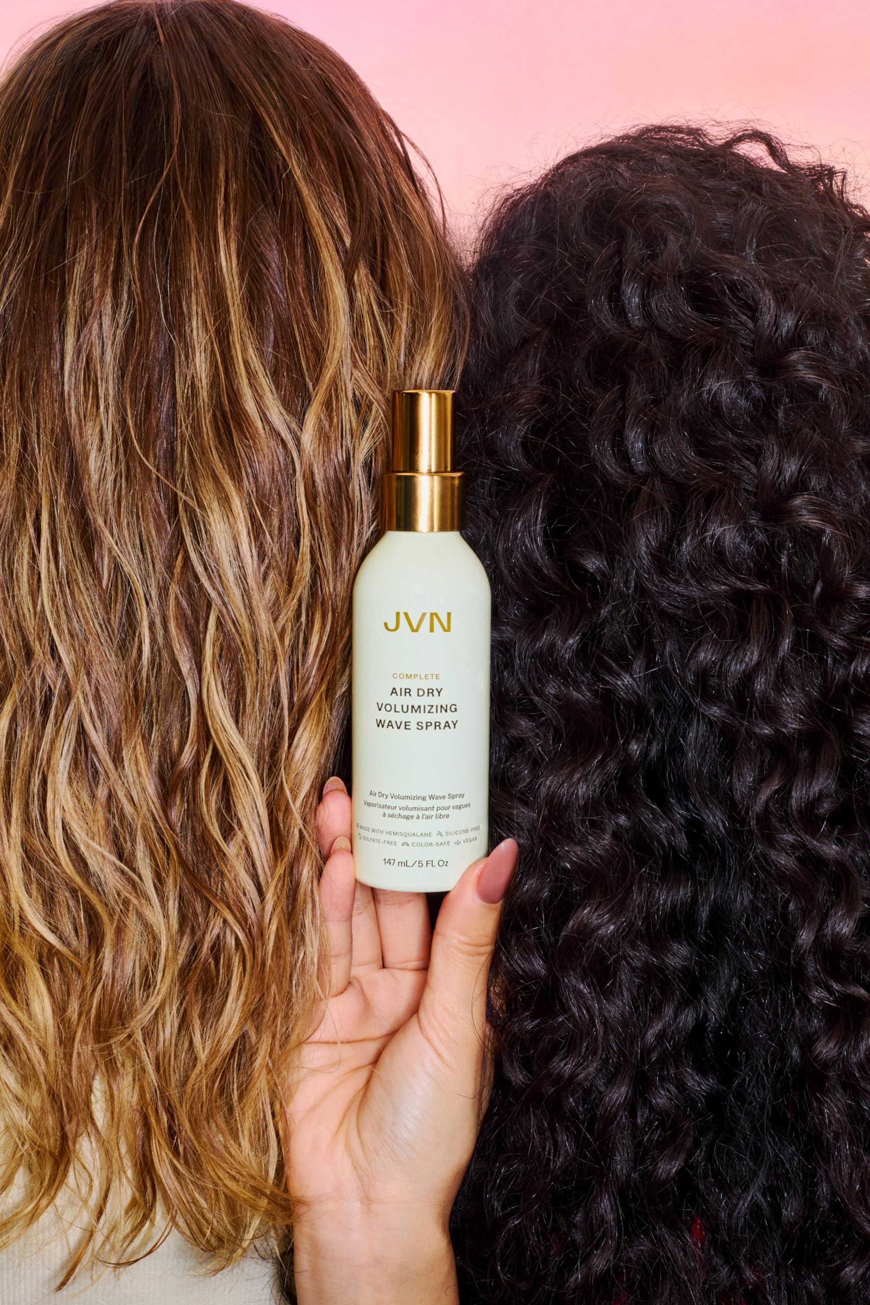 JVN spray in hand applying lightweight boost for natural volume