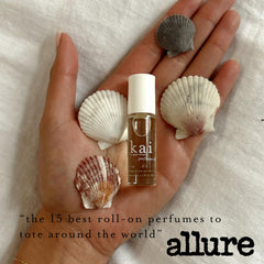 kai bottle scale against fingers demonstrating 1/8 oz travel-friendly size