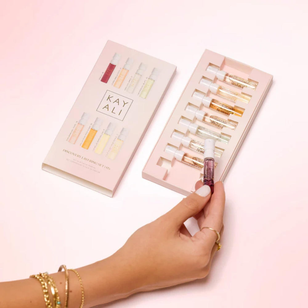 KAYALI 1.5ml mini spray in hand to show compact travel-friendly scale