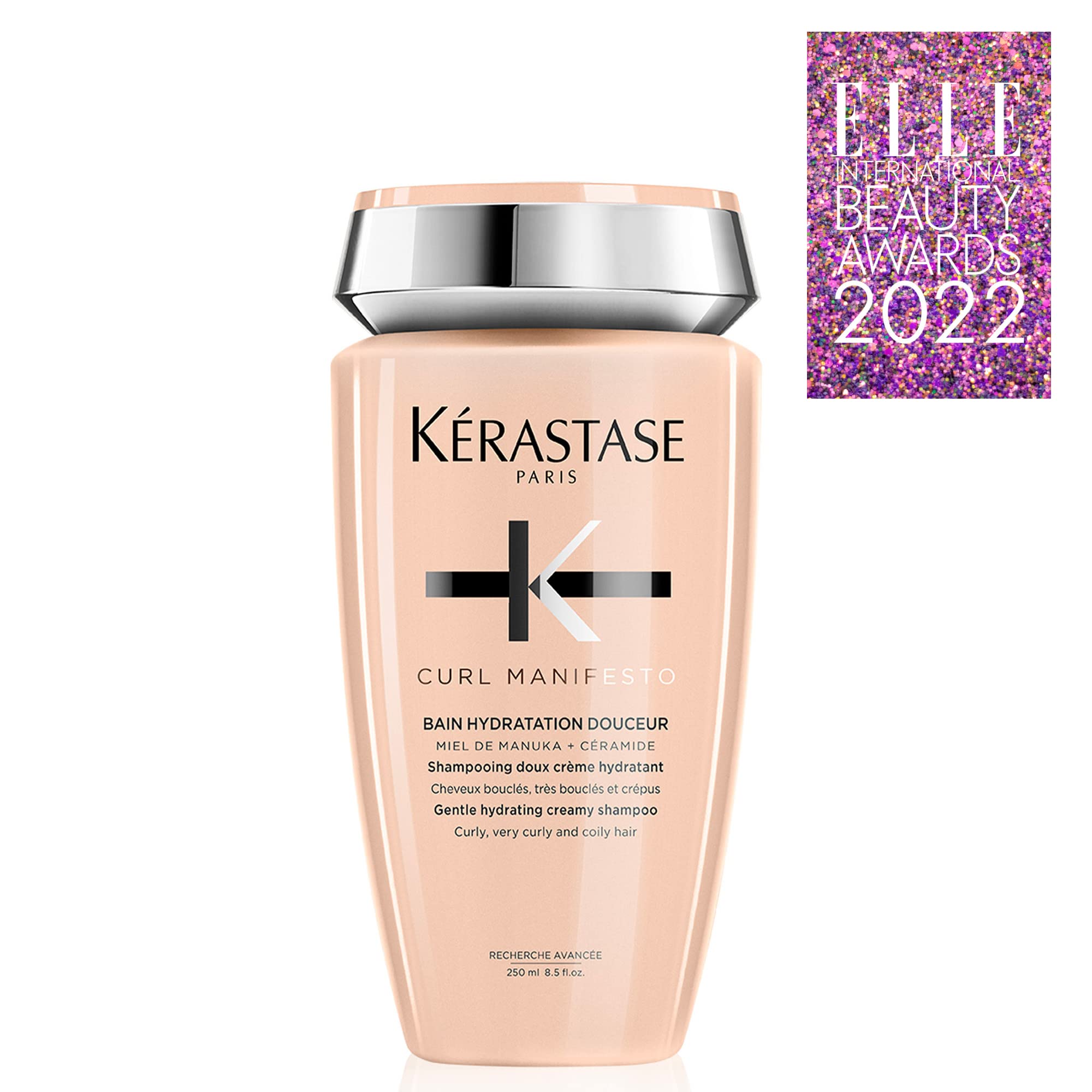 KÉRASTASE bottle next to hand for clear size and scale