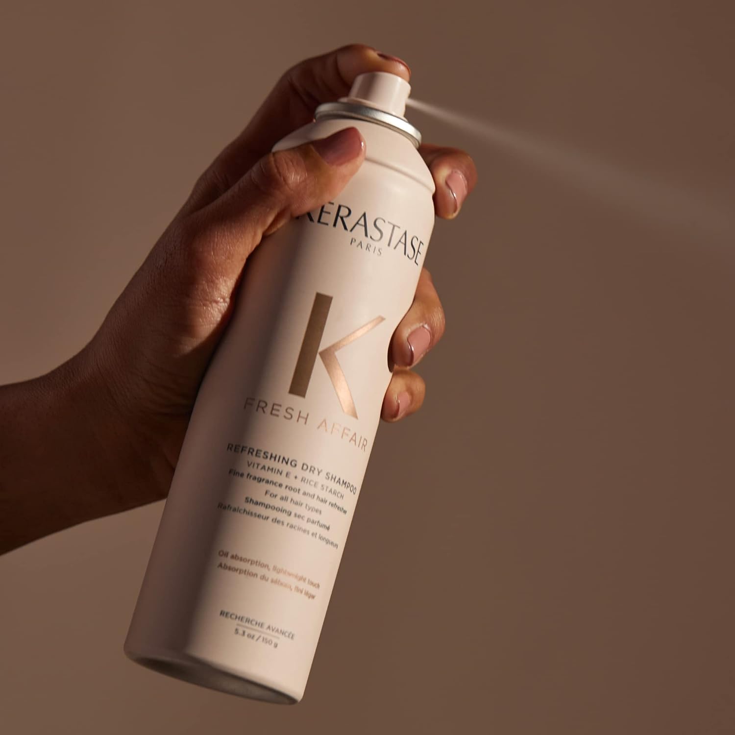 KÉRASTASE can next to ruler for size comparison, highlighting travel-friendly 5.3 fl oz