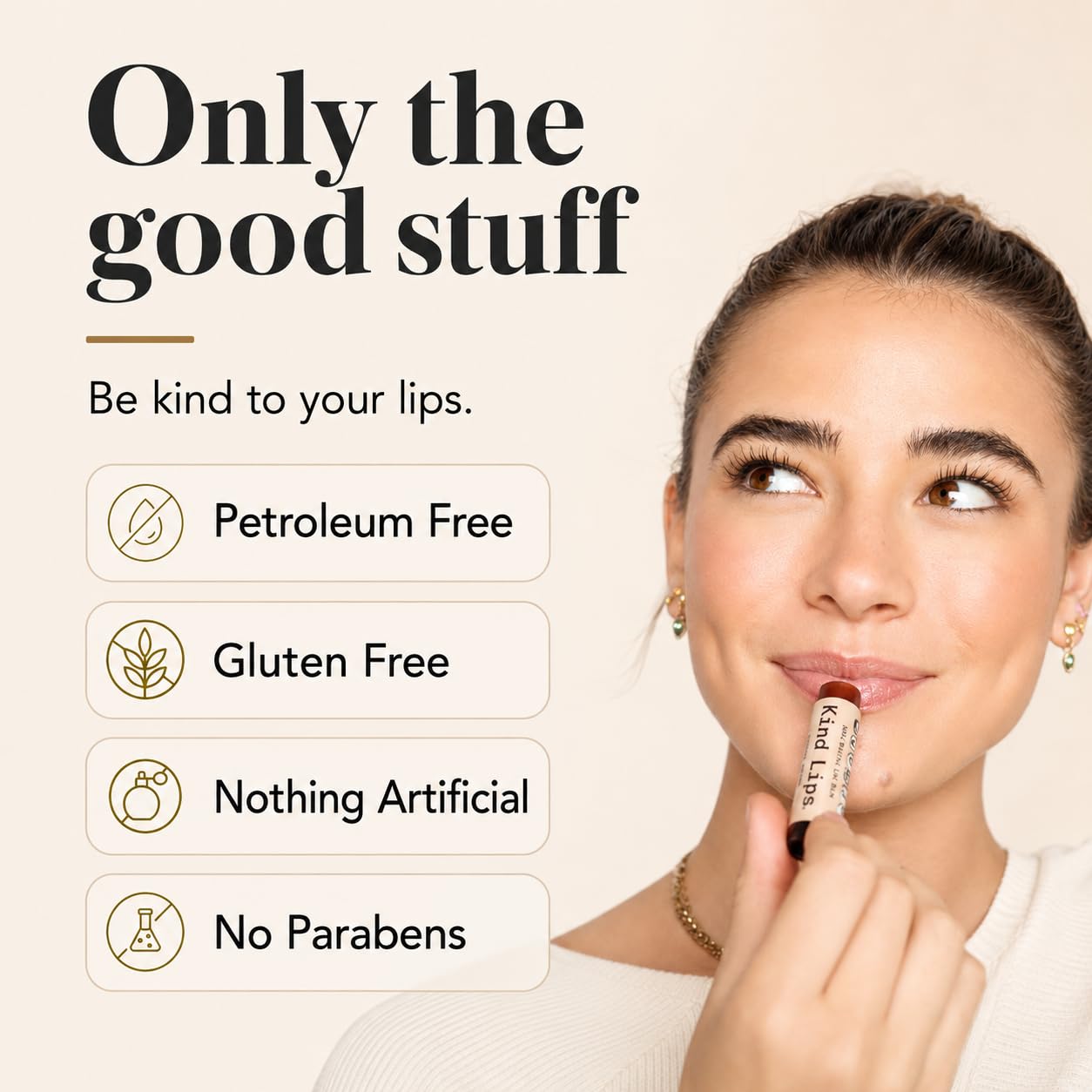 Kind Lips tube held in hand to show scale and portability, convenient for pockets and travel