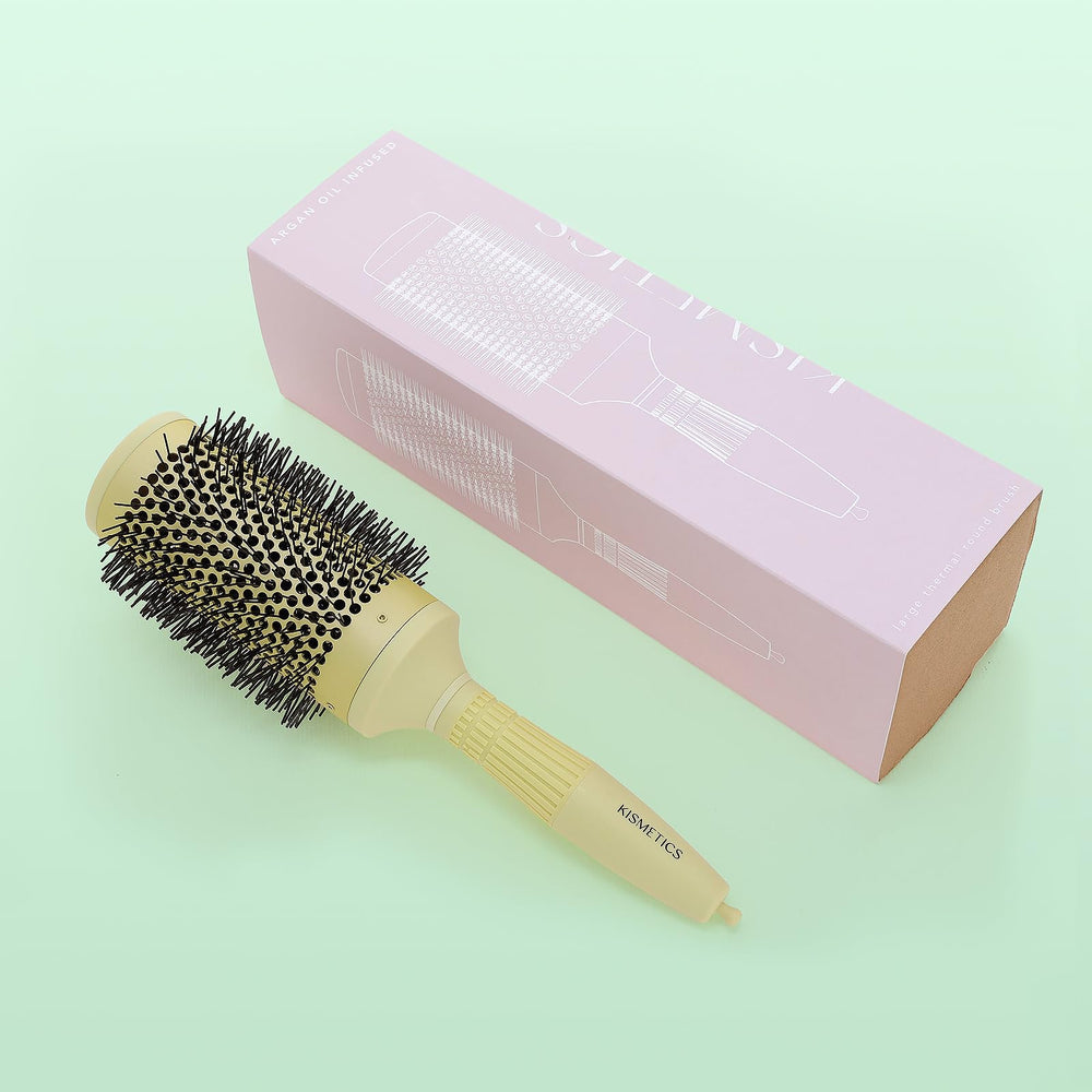 KISMETICS brush on bathroom counter staged for a home salon blowout routine