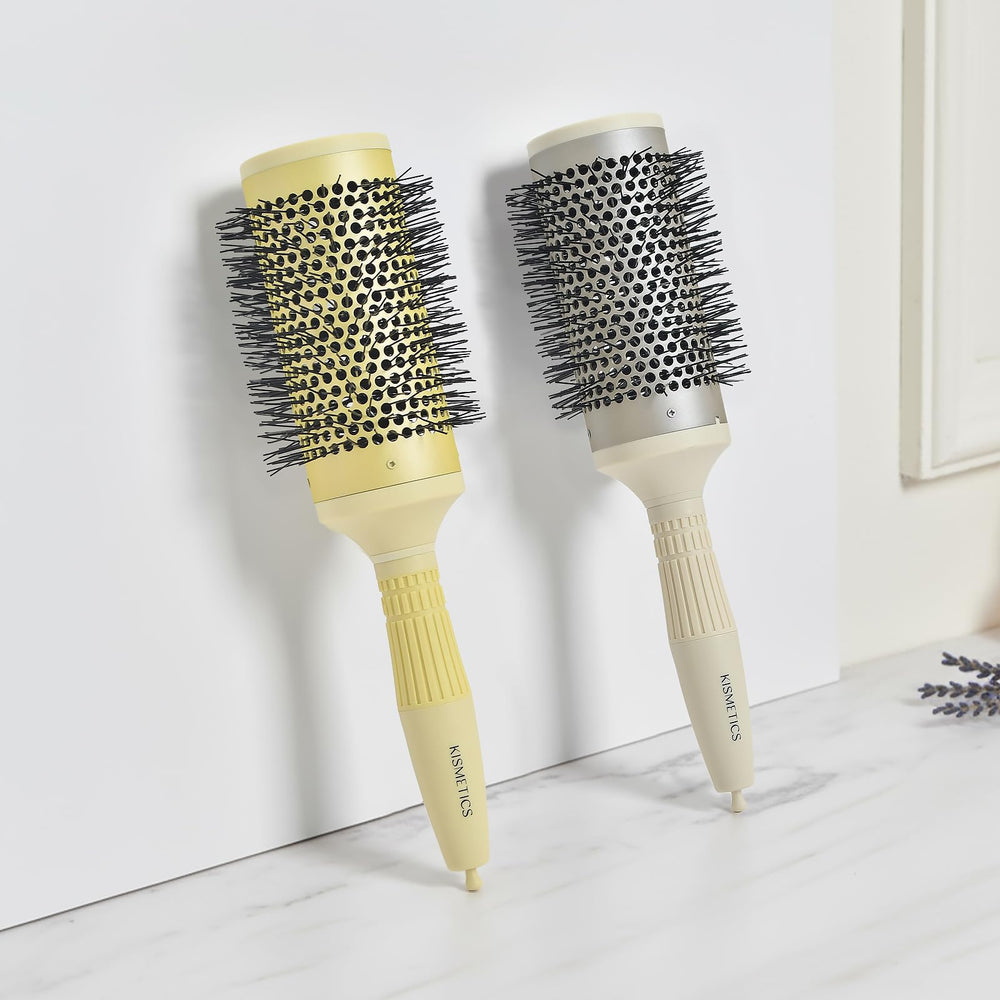 KISMETICS brush next to hand to show 2.1" barrel size and styling scale