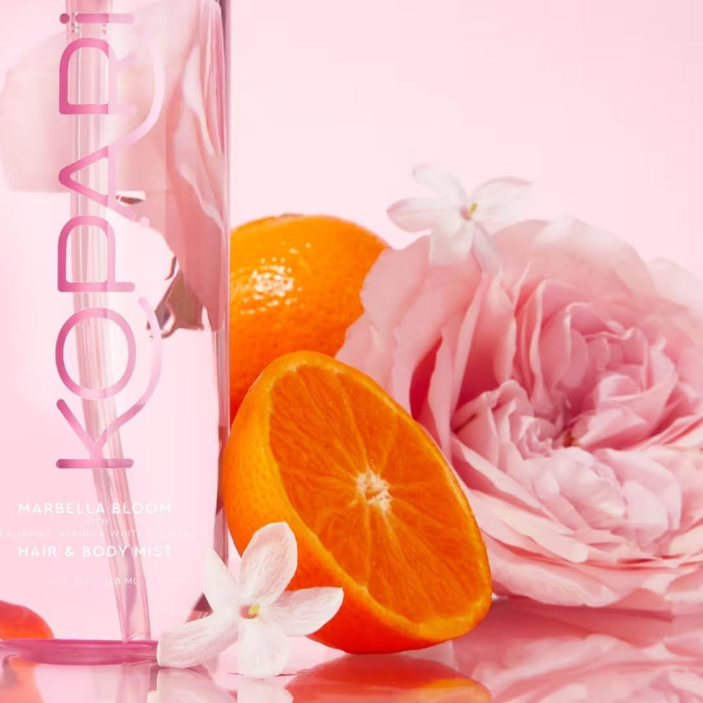 Kopari being spritzed into hair for lasting, layered fragrance