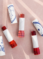 KORRES mulberry lip butter applied on lips in lifestyle shot for natural glossy look