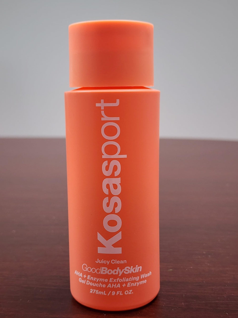 Kosas body wash in use on arm showing smoother skin result