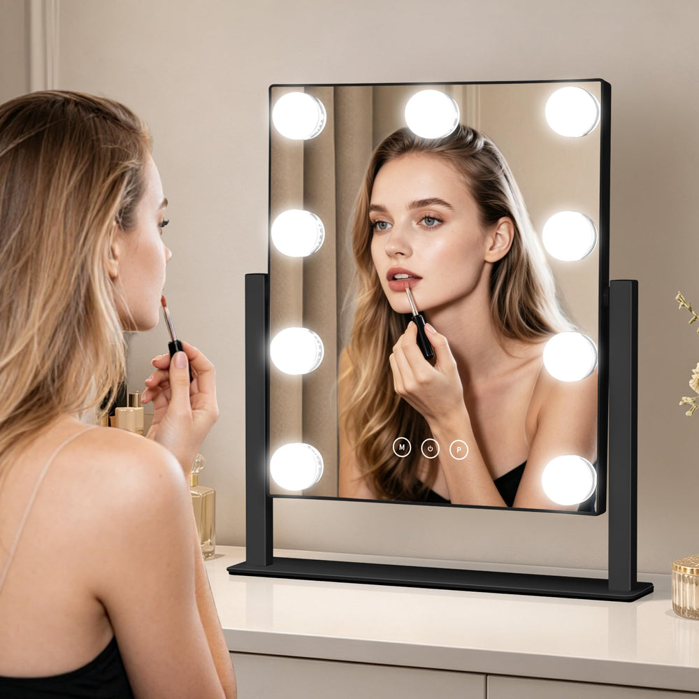 Kotdning mirror held by hand to show compact size and easy portability