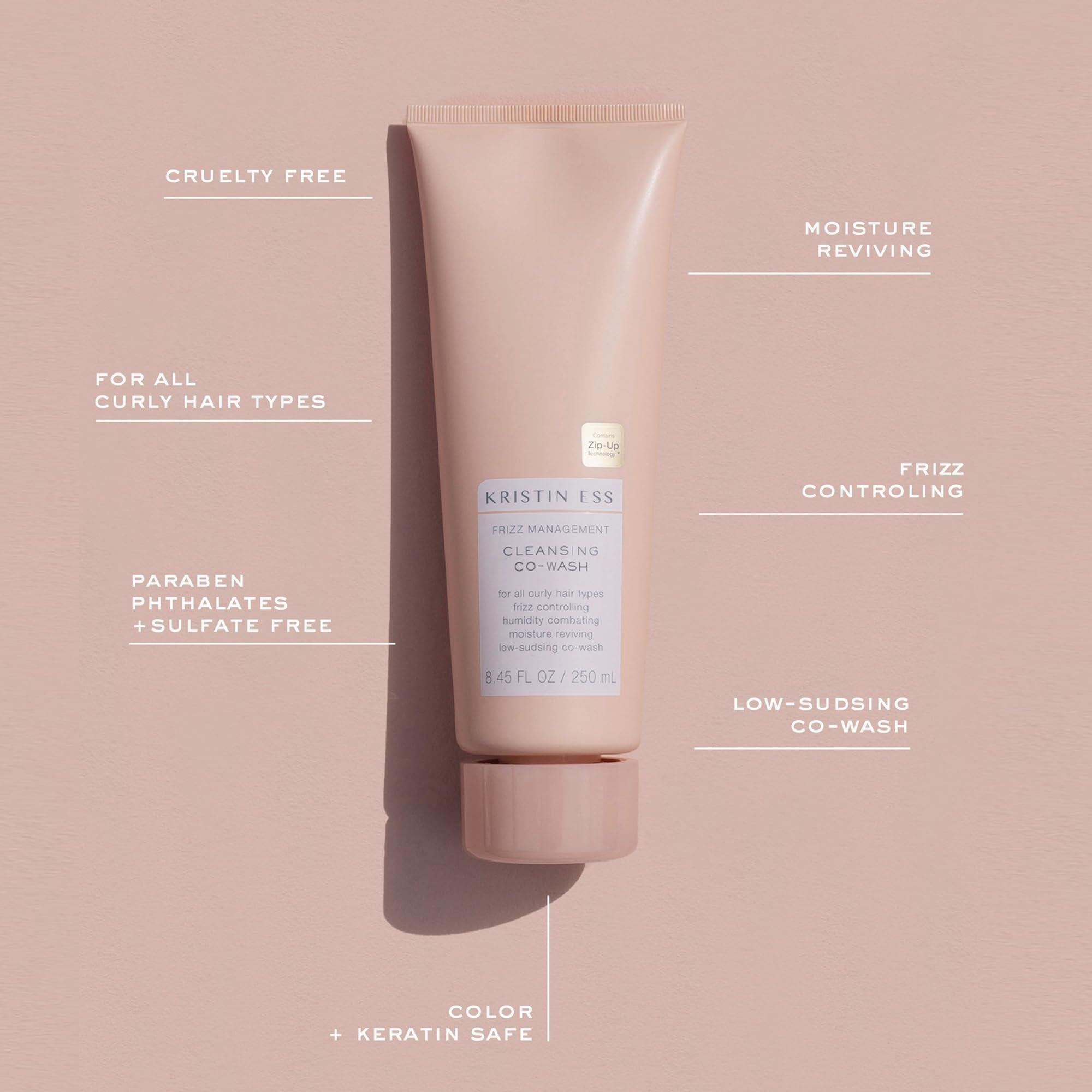 Applying Kristin Ess co-wash to wet hair for gentle cleansing and slip