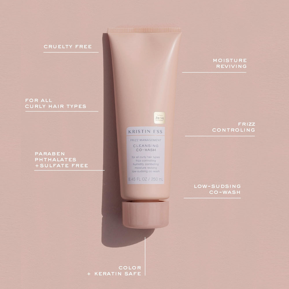 Applying Kristin Ess co-wash to wet hair for gentle cleansing and slip