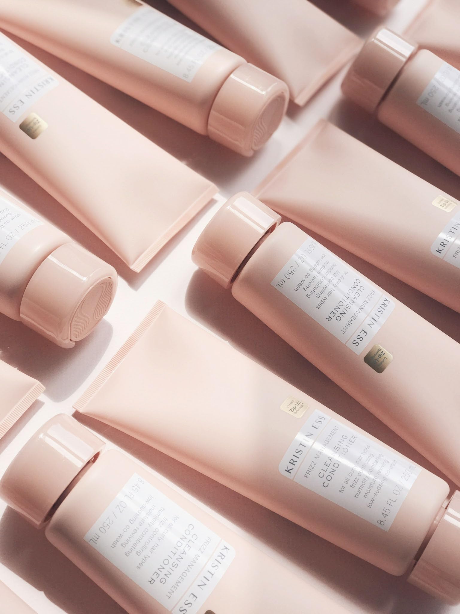 Kristin Ess bottle styled on bathroom shelf suggesting daily routine ease
