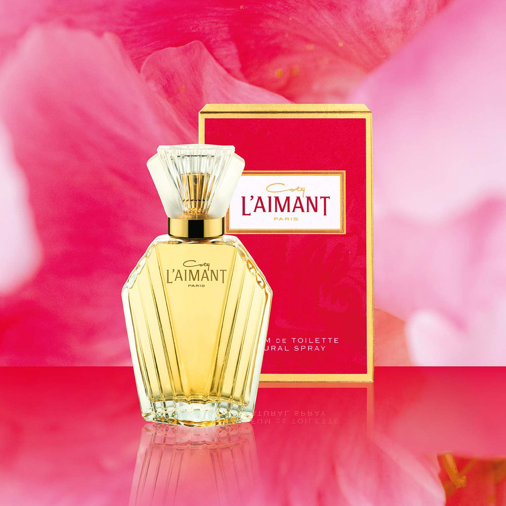 L'Aimant by Coty bottle held in hand displaying compact 1.7 oz size benefit