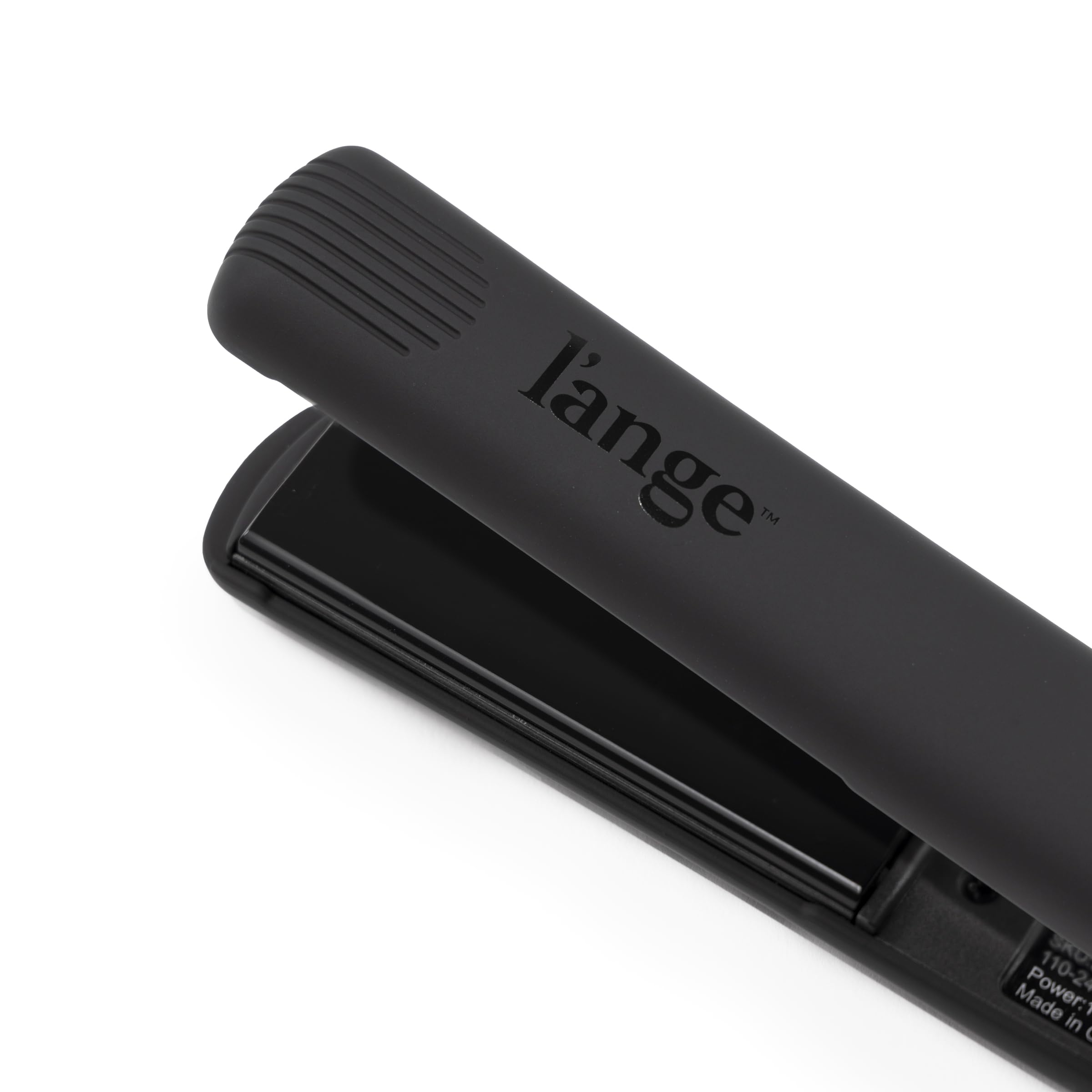 L'ANGE HAIR size comparison in hand showing compact 1-inch plate for precision