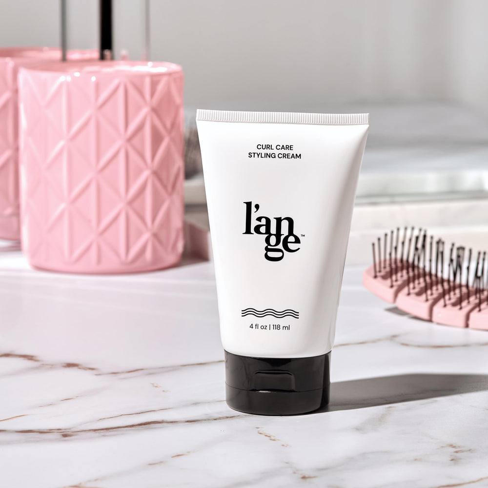 L'ANGE HAIR cream on bathroom vanity in lifestyle scene showing everyday styling ease