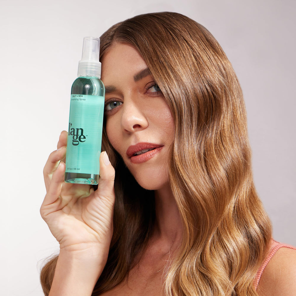 L'ANGE HAIR spray tucked in a bag ready for quick on-the-go refresh