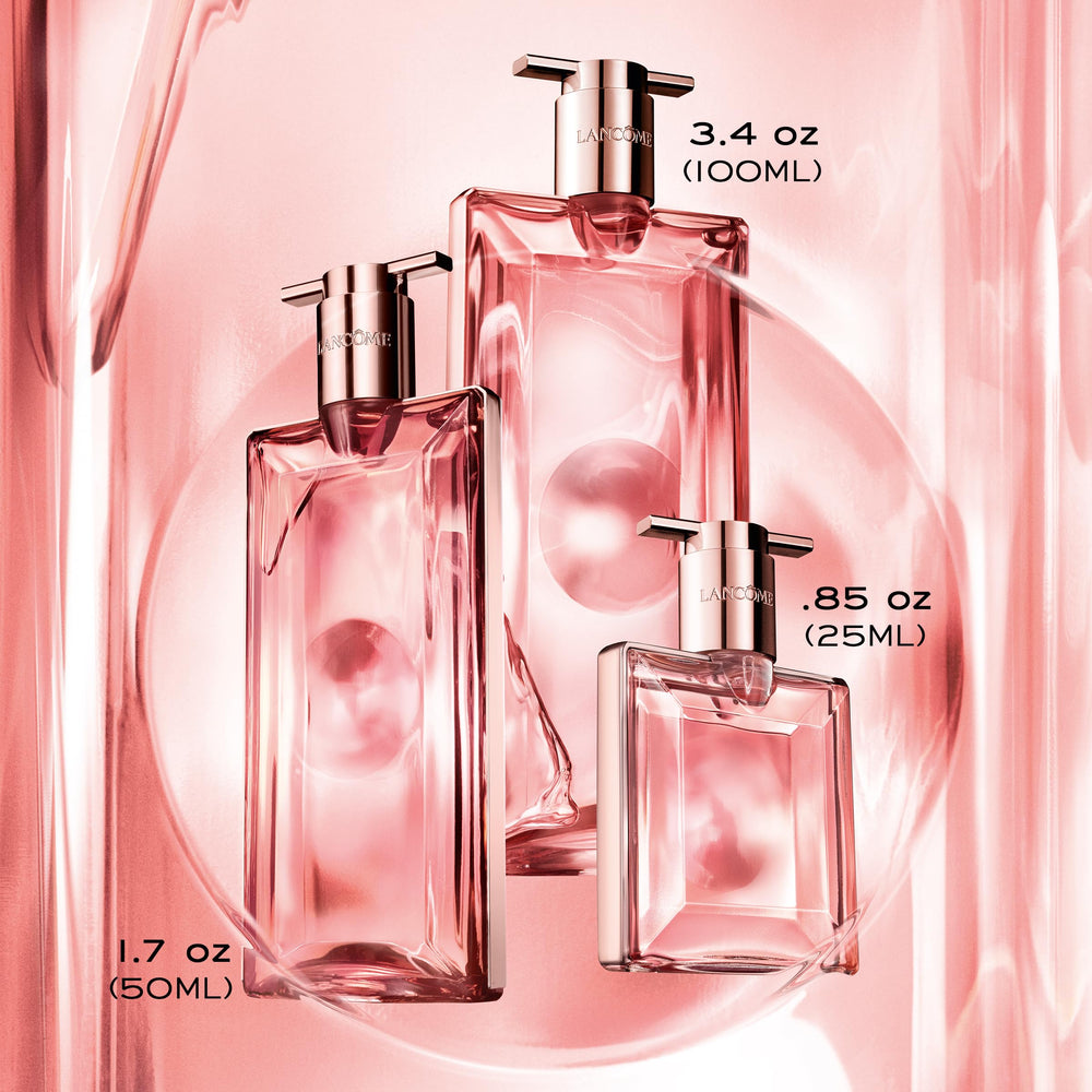 Lancôme Idôle bottle staged on vanilla and driftwood to hint warm base notes benefit