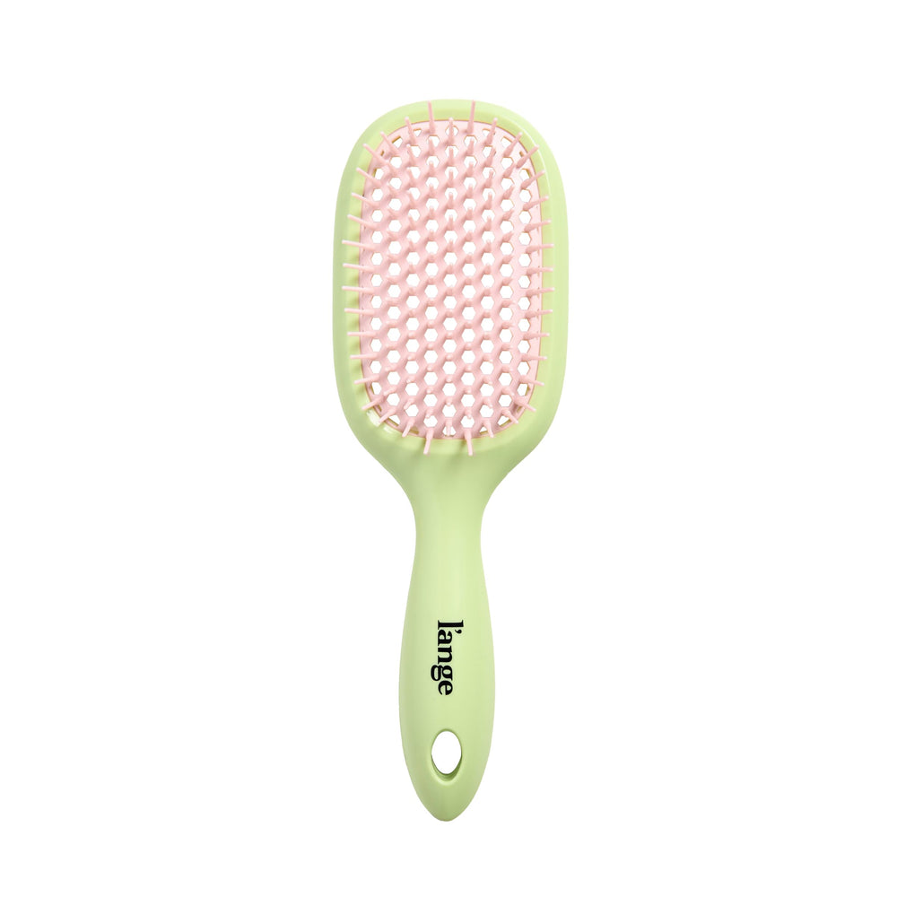 L'ANGE HAIR brush next to ruler showing compact size and travel-friendly benefit