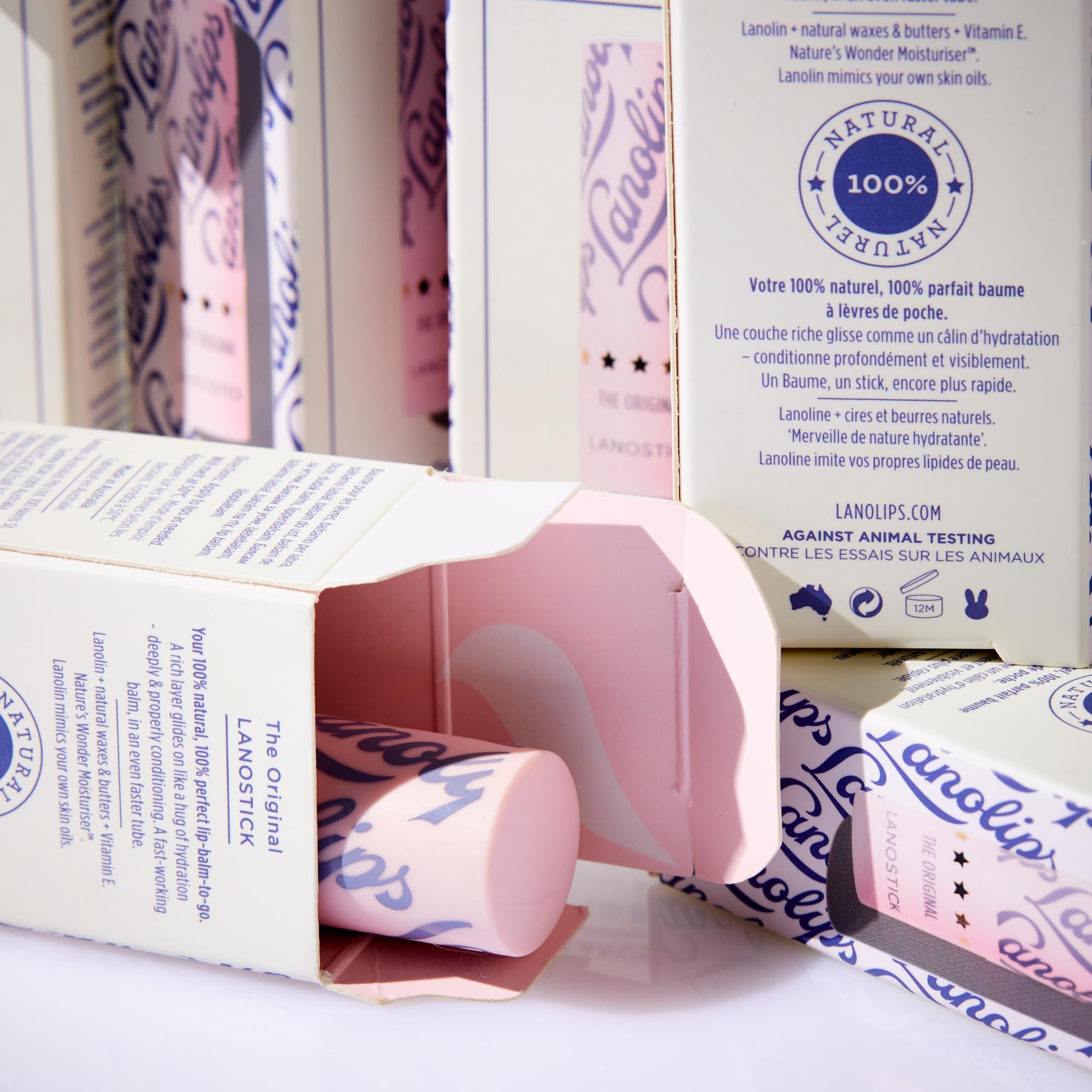 Hand applying Lanolips Lanostick to lips demonstrating easy glide and instant softness benefit