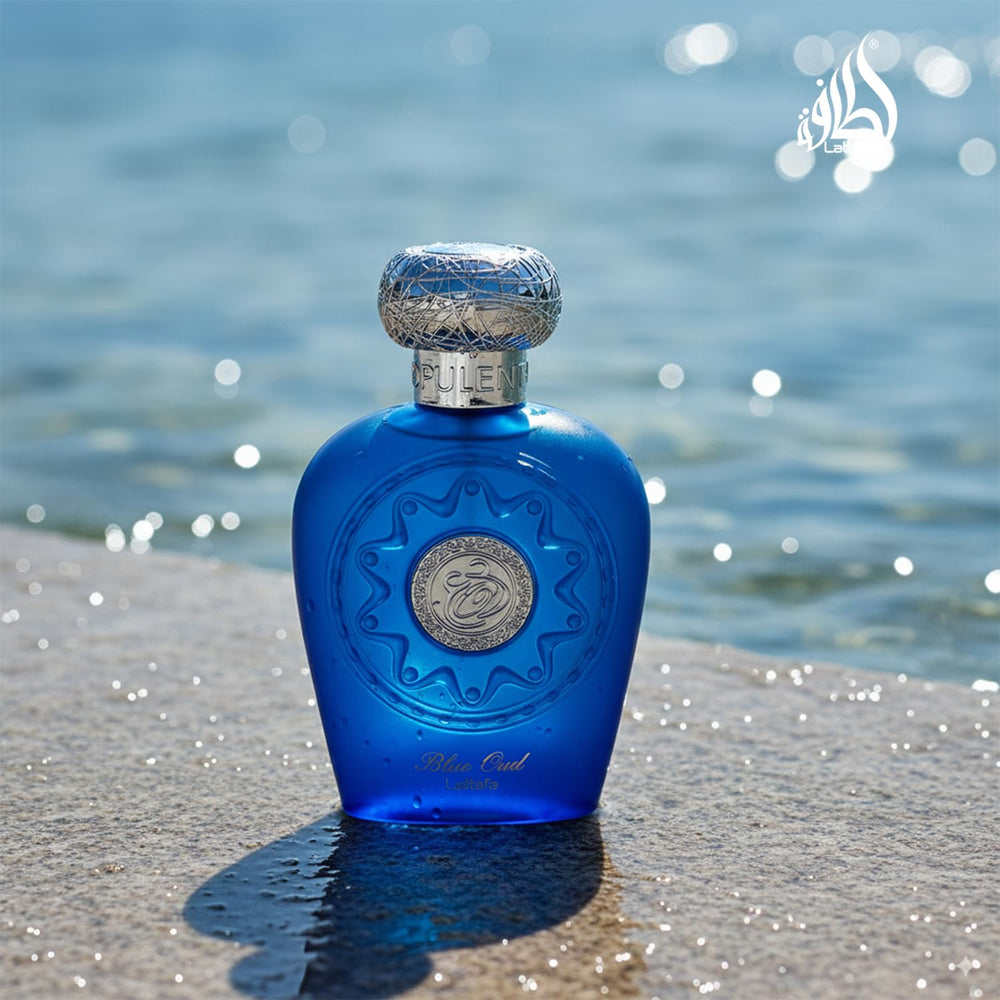 Lattafa Blue Oud held in hand showing 3.4 oz scale and travel practicality