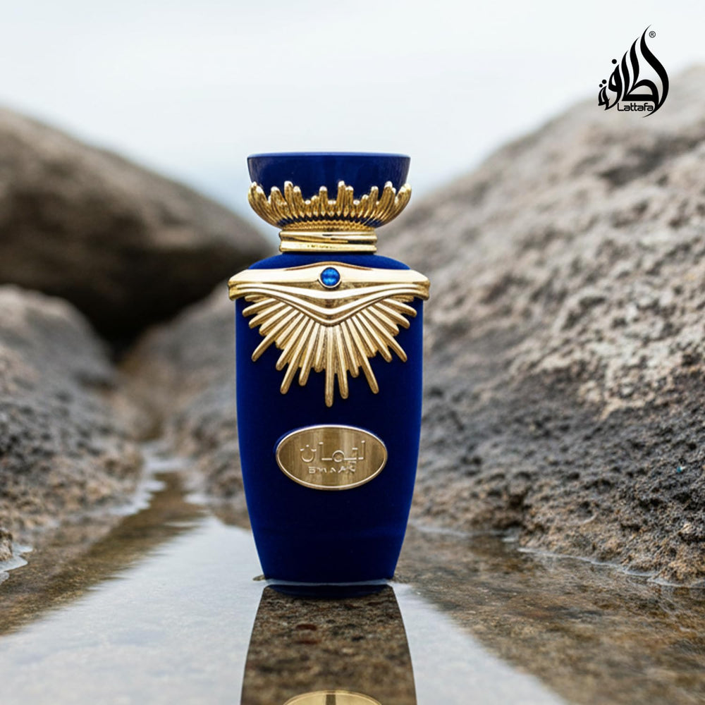 Lattafa Emaan bottle on wooden table evoking warm woody base and mood