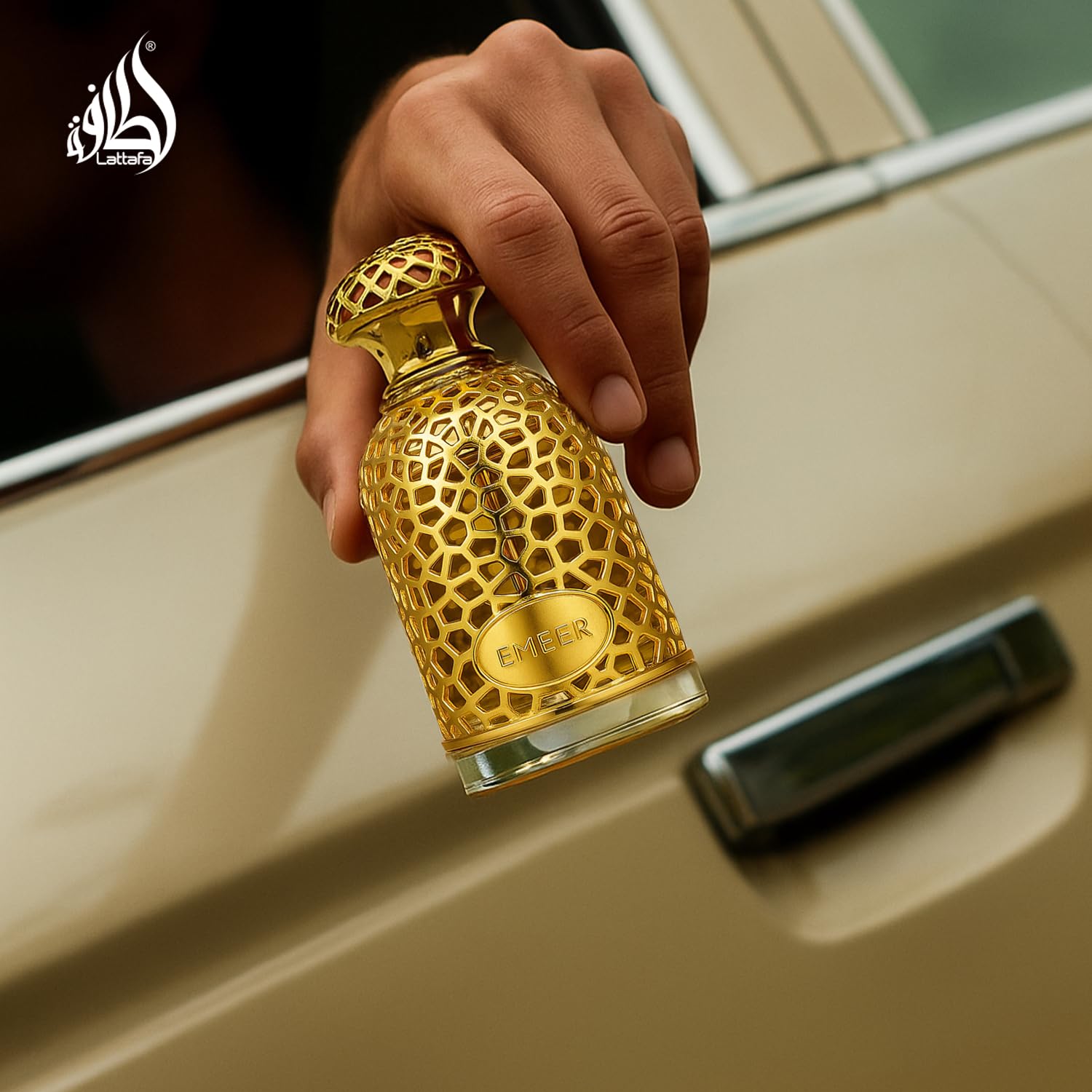 Lattafa Emeer bottle on wood highlights warm woody drydown and lasting depth