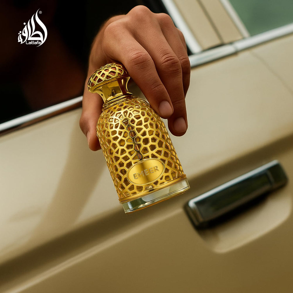 Lattafa Emeer bottle on wood highlights warm woody drydown and lasting depth