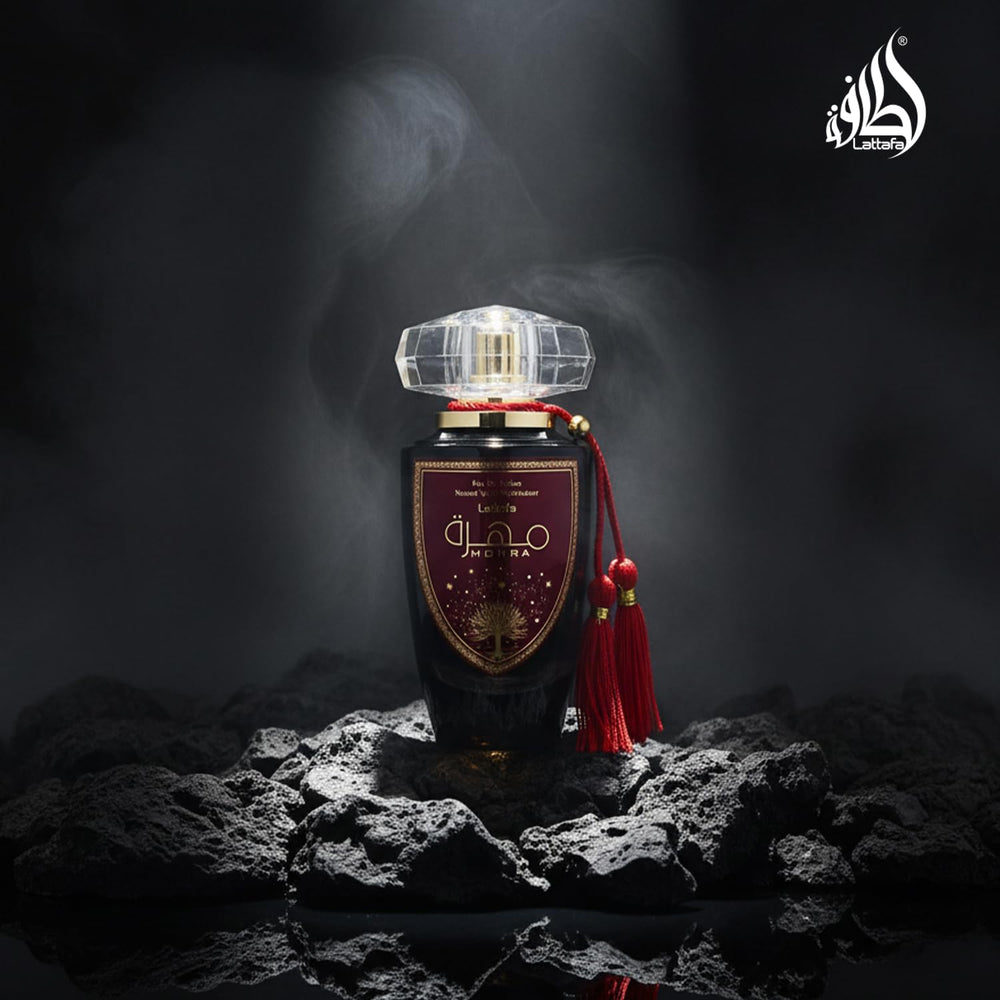 Lattafa Mohra next to a ruler and common items showing true 100ml scale and value