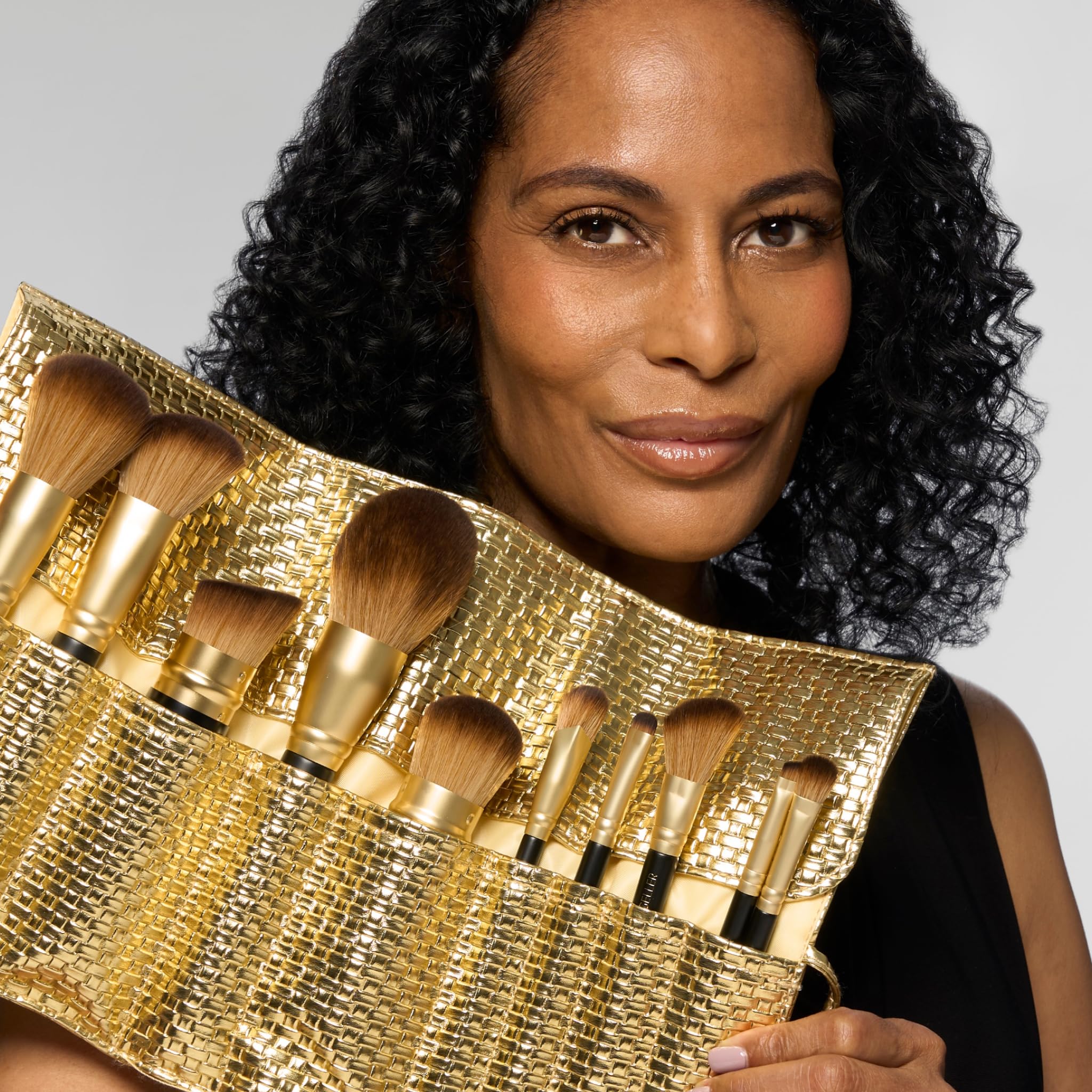 LAURA GELLER NEW YORK brush applying foundation showing smooth, streak-free finish benefit