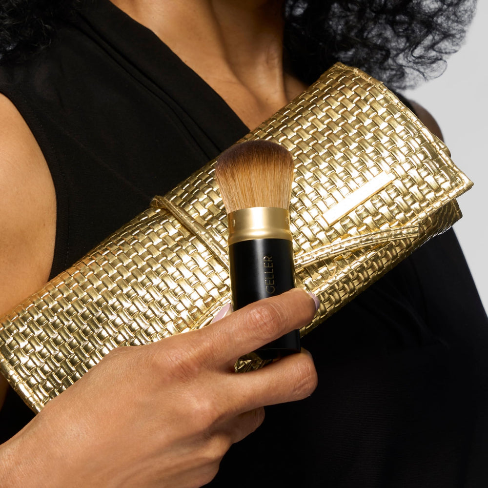 LAURA GELLER NEW YORK brush next to a ruler showing compact size and portability benefit