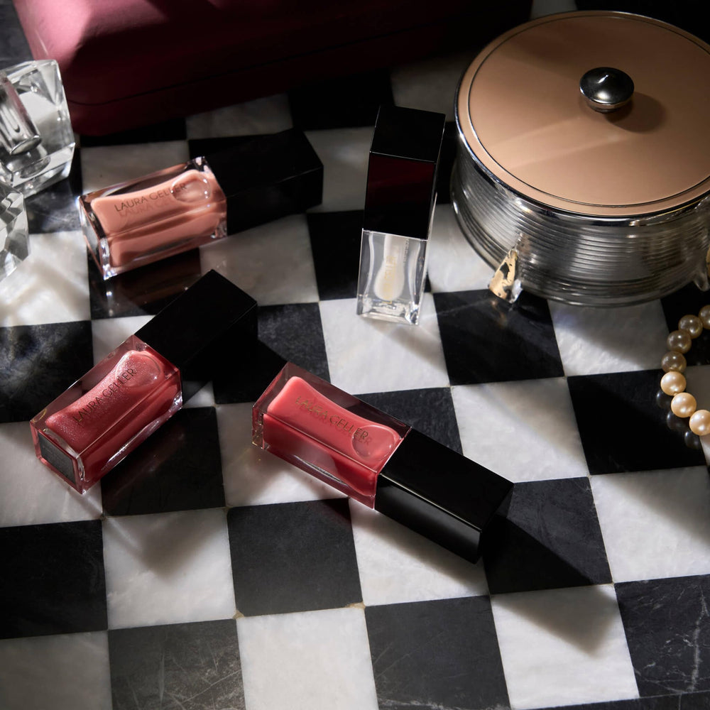 LAURA GELLER lip oil styled in a cozy lifestyle scene conveying everyday wearability