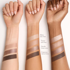 Laura Mercier swatches on arm illustrating creamy pigment and blendable finishes