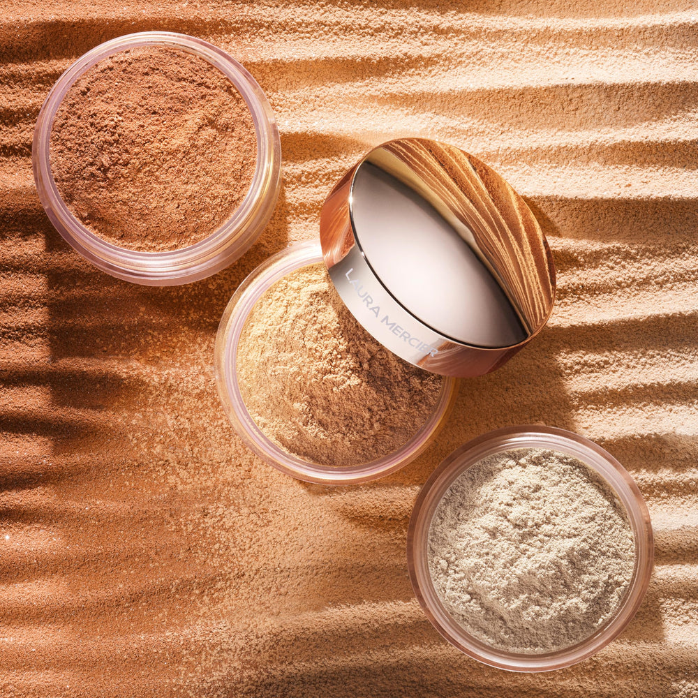 Laura Mercier powder applied with velour puff demonstrating application for long-lasting set benefit