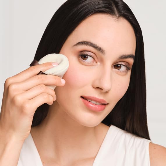 Laura Mercier velour puff in use pressing loose setting powder onto cheek for matte finish