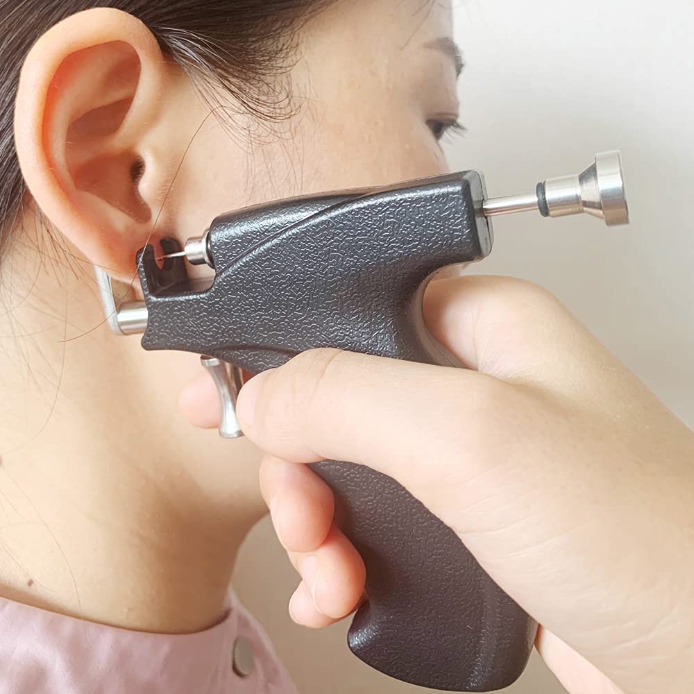 LECIEL piercing gun in hand to show scale and ergonomic grip for controlled use
