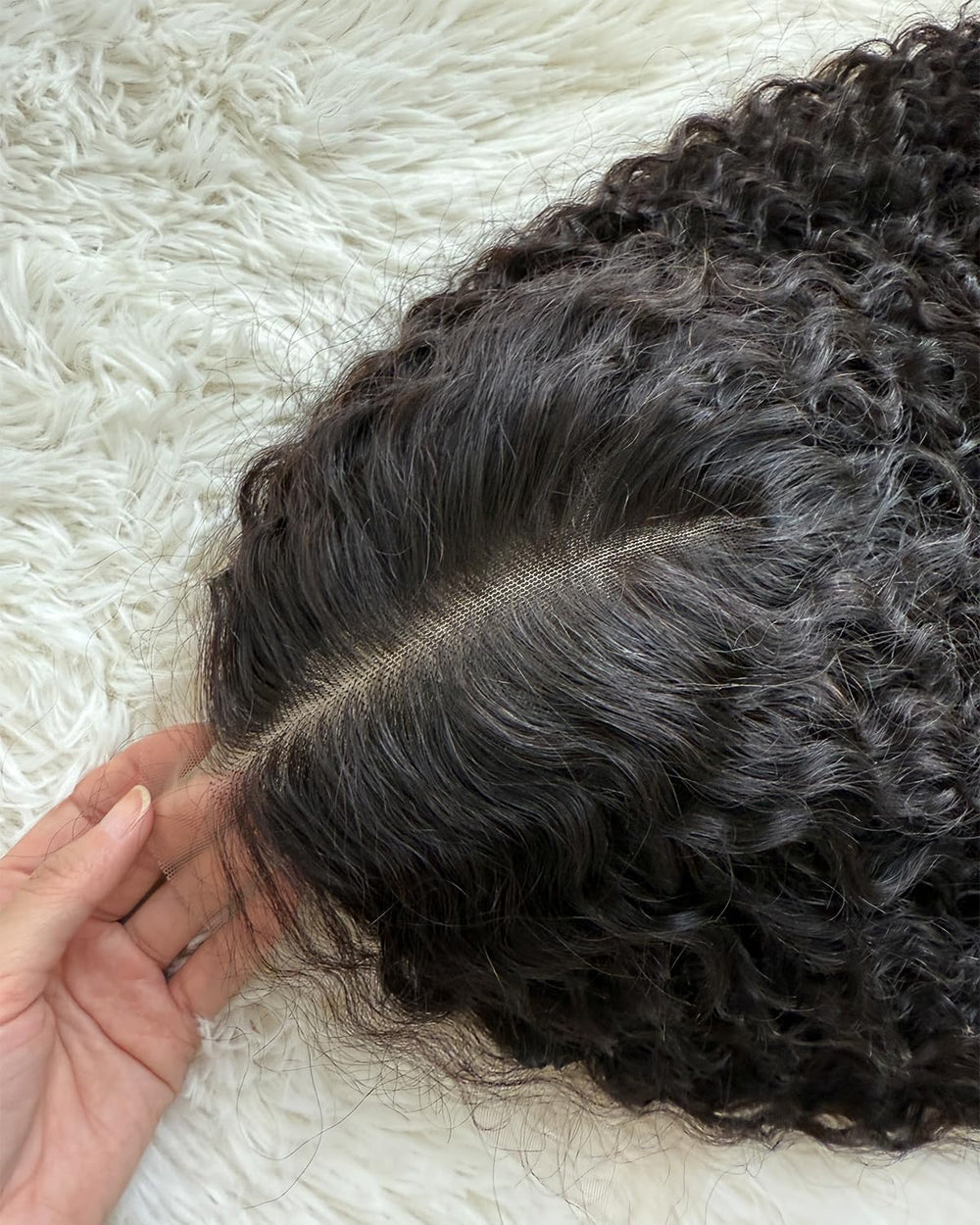 Lemoda wig held in hand showing scale and true-to-length indication