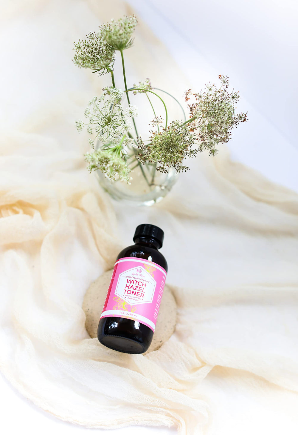 Leven Rose toner held in hand showing compact 4 oz travel size