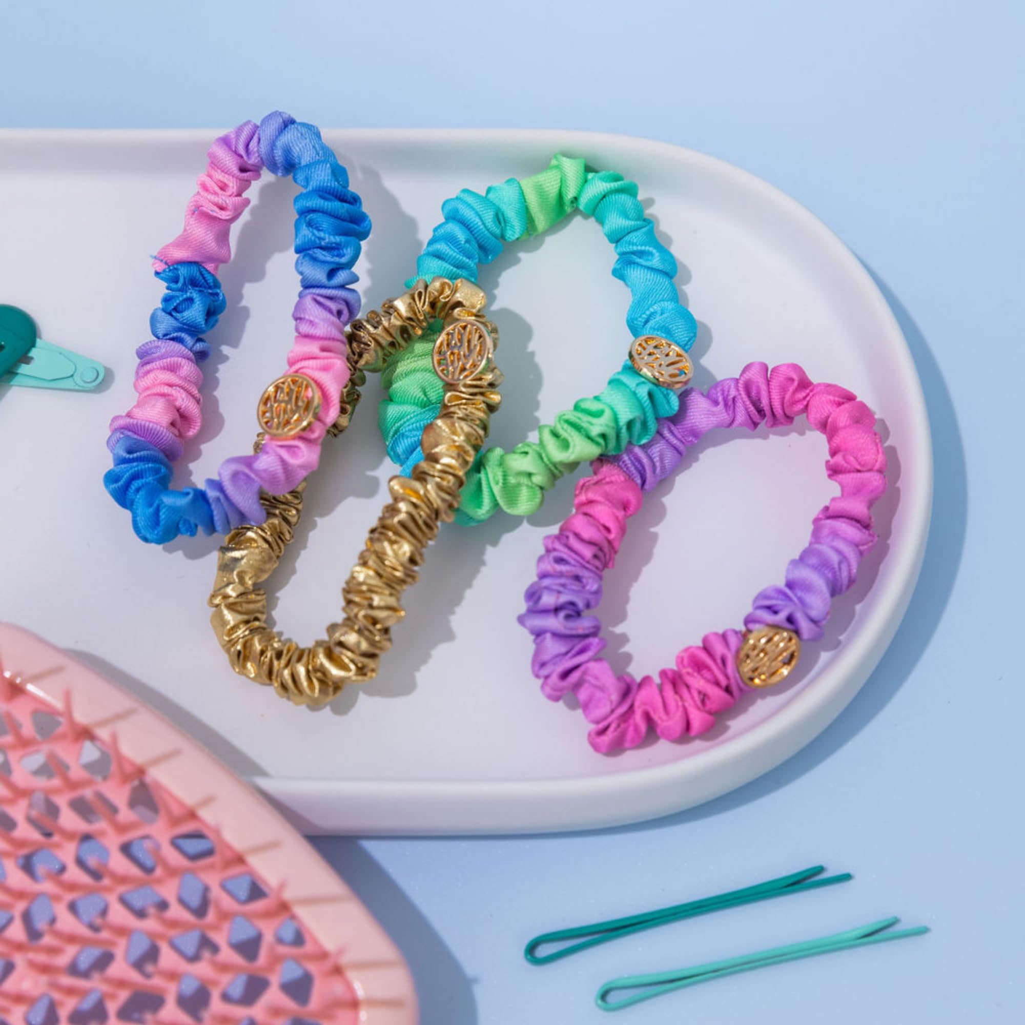 Lilly Pulitzer scrunchie next to hand showing scale and easy everyday wear