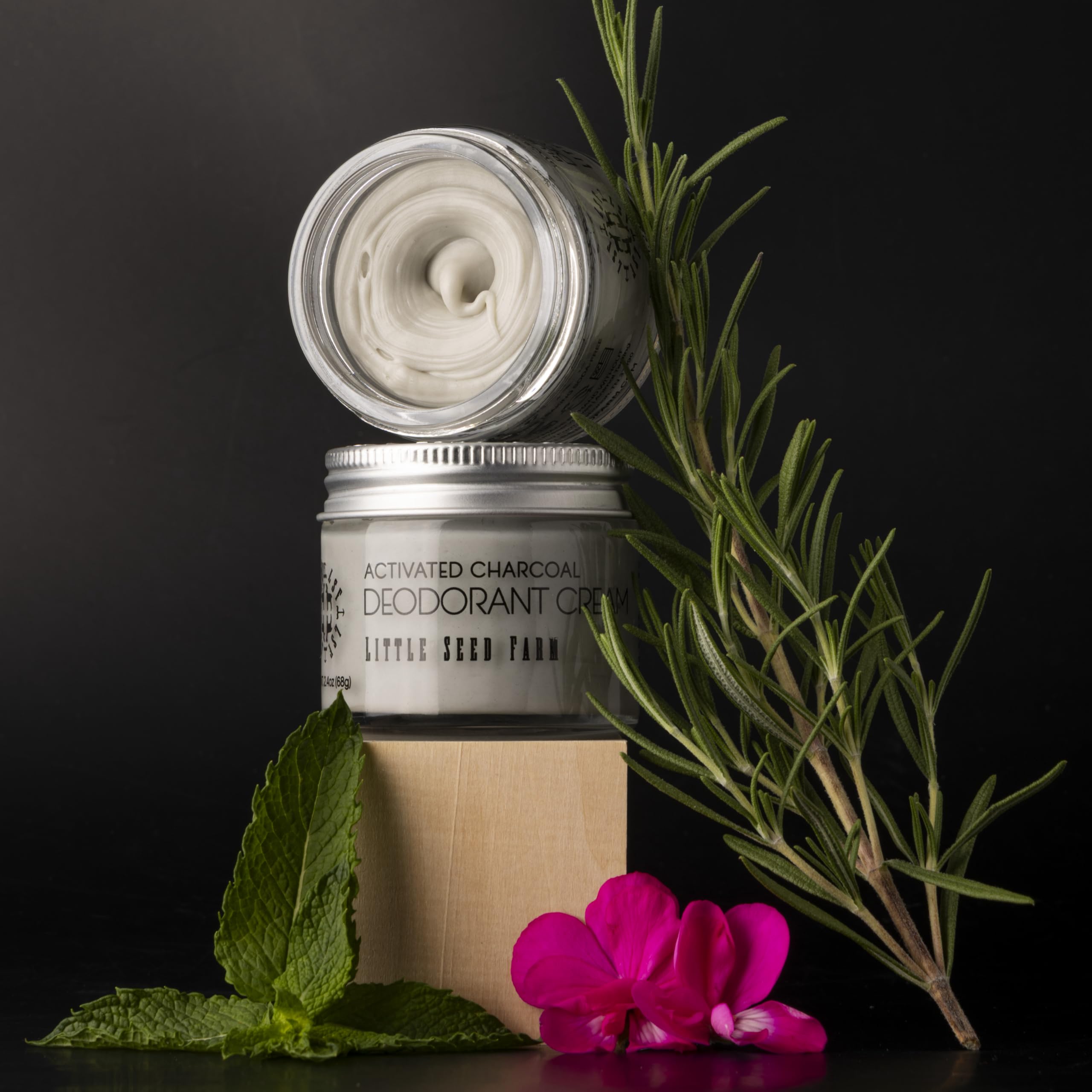 Little Seed Farm ingredient flatlay with activated charcoal and botanicals for transparency