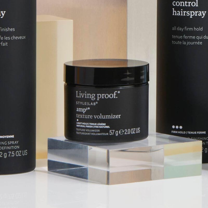 Model applying Living Proof Amp Texture Volumizer to dry hair, demonstrating root lift and natural textured finish