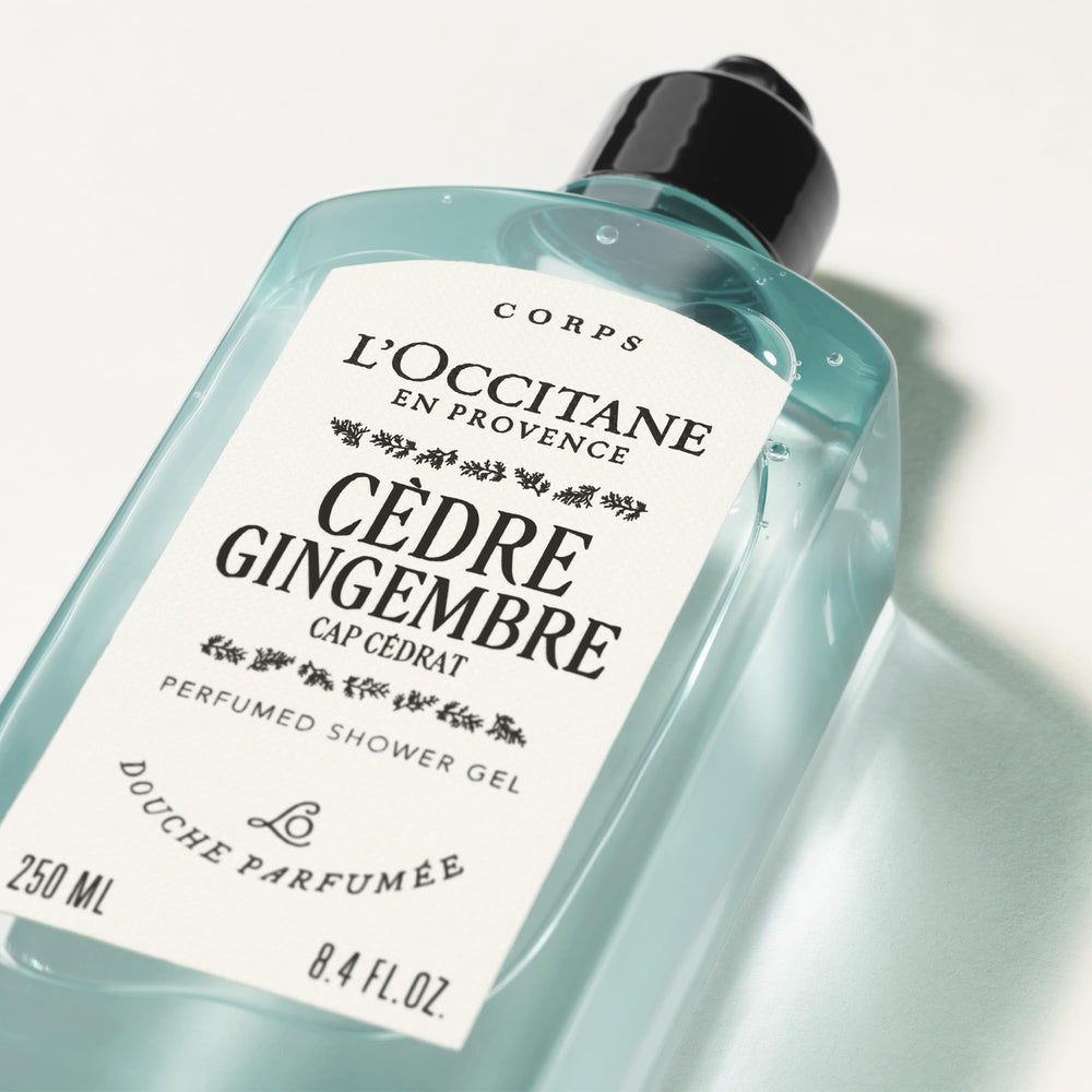 L'OCCITANE bottle held in hand for scale to show travel-friendly size