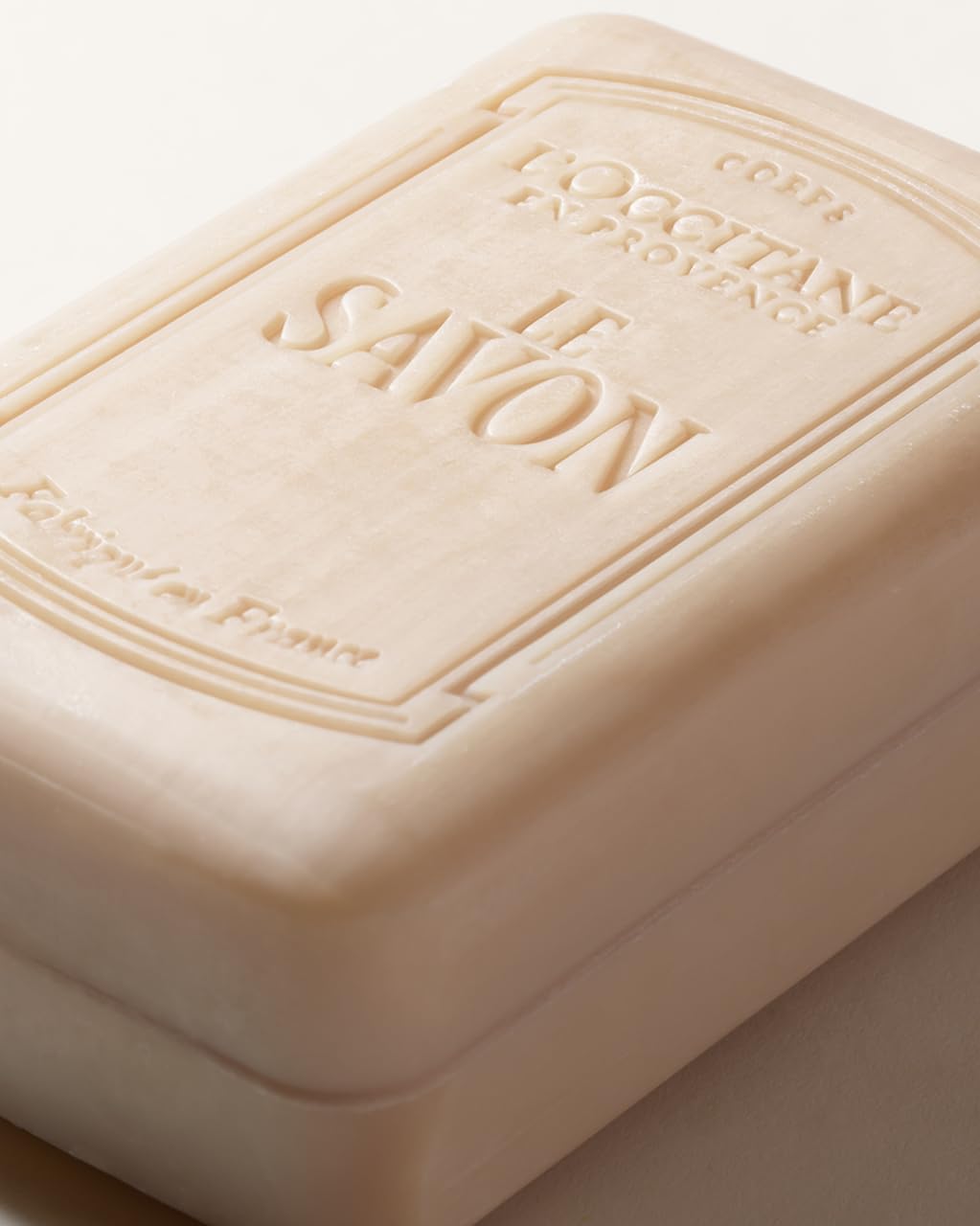 L'OCCITANE shea milk soap next to common items showing 8.8 fl oz scale and value