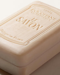 L'OCCITANE shea milk soap next to common items showing 8.8 fl oz scale and value