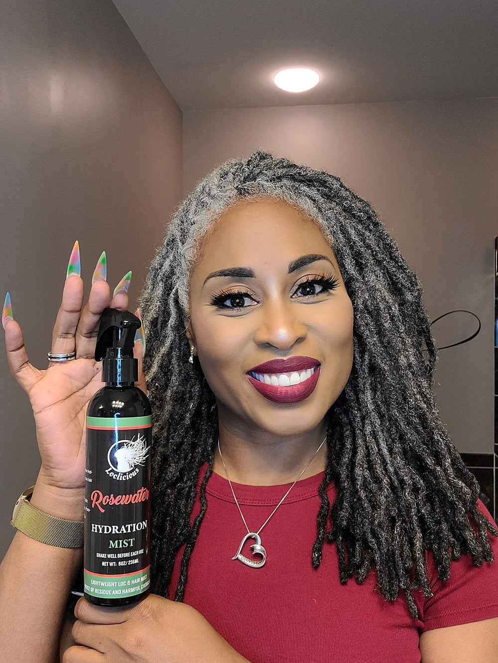 Person with dreadlocks using LOCLICIOUS mist in a lifestyle setting to soothe and refresh scalp