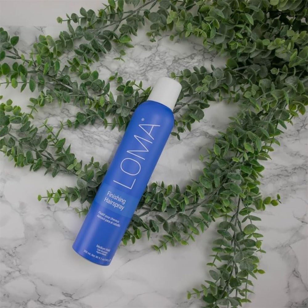 Loma finishing hairspray size comparison in hand showing 9.1 oz portable styling convenience