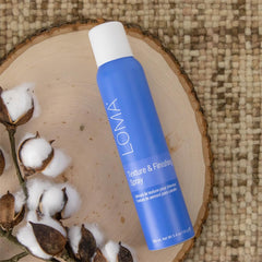 Loma bottle held in hand to show size and portability, easy styling benefit