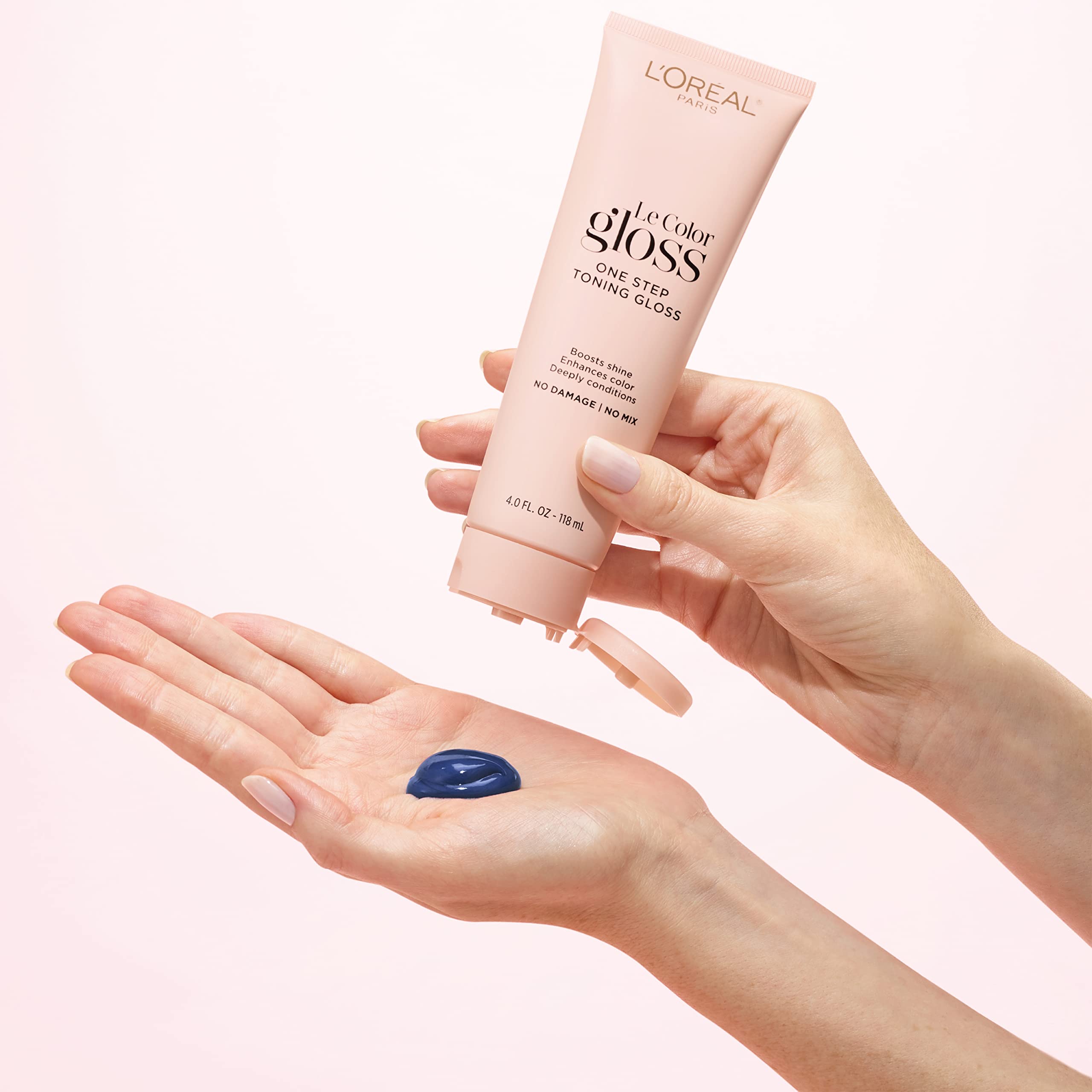 Lifestyle scene of person styling silver hair after using L'Oreal Paris gloss for confidence