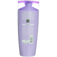 L'Oreal Paris bottle dispensing clear lather highlighting easy application