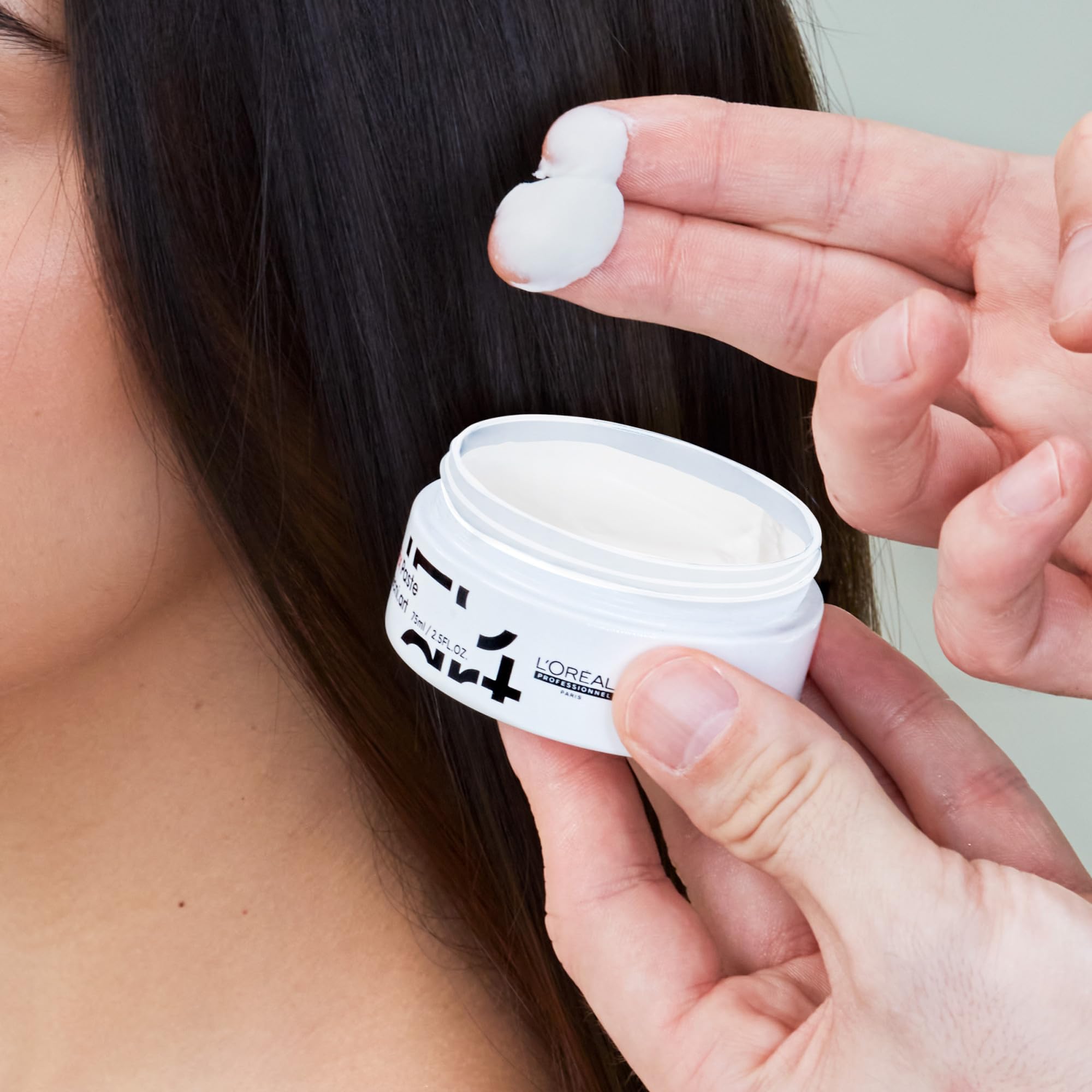 L'Oréal Professionnel jar beside a coin showing compact travel-friendly size
