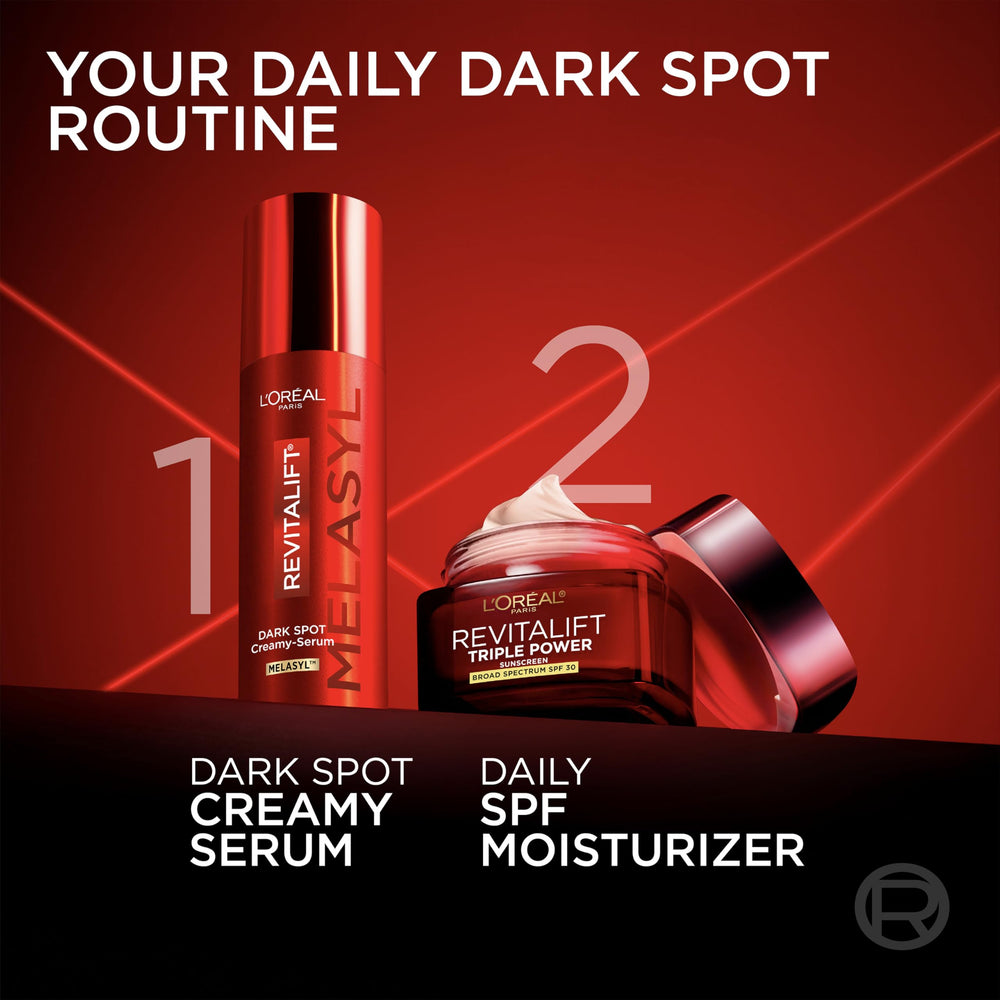 L'Oreal Paris serum on vanity next to moisturizer and sunscreen, shows routine use